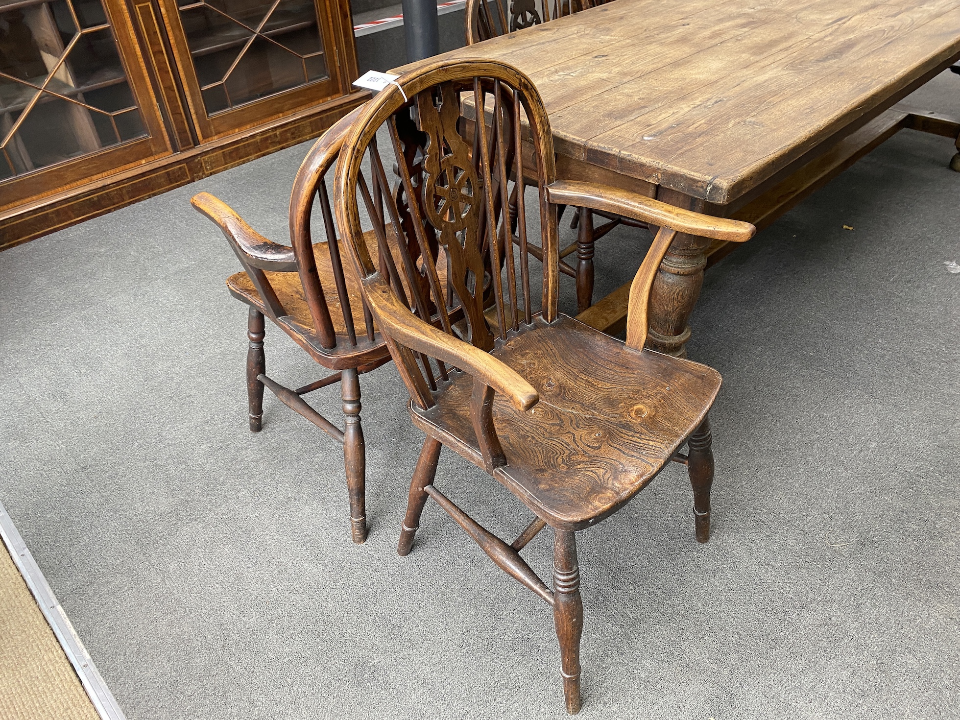 A harlequin set of ten 19th century ash and elm Windsor wheelback dining chairs, two with arms
